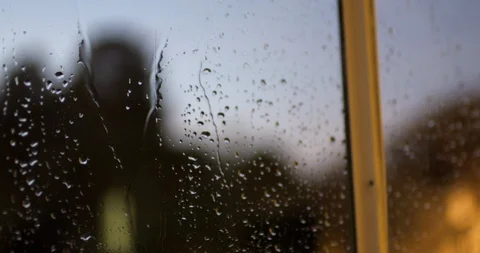 Rain trickles down the windows during a twilight storm. 스톡 동영상 88369641