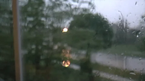 Rain trickling down a window, looking out at a thunderstorm Stock Footage 93782456
