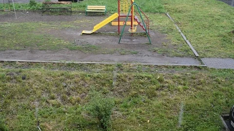 Rain in the urban environment on an empty children's Playground Stock Footage 94055537