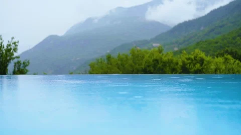 Rain; View from the edge of pool; surrounding mountains Stock Footage 116544875