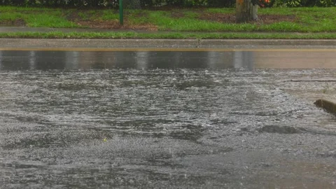 Rain water draining to the street Stock Footage 134490472