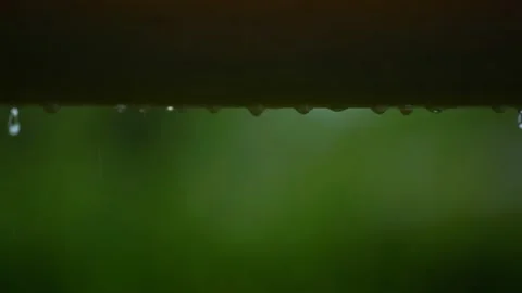 Rain water drips from a roll of plastic awnings.Heavy rain in summer. Video stock 218411885