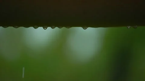 Rain water drips from a roll of plastic awnings.Heavy rain in summer. Video stock 218411937