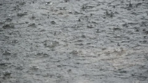 Rain water drop falling to the city street floor in heavy rain day Stock Footage 140917067