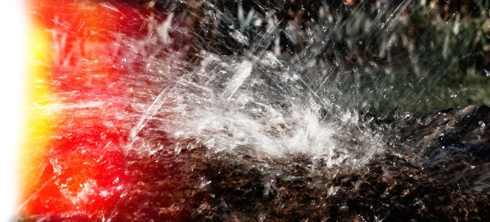 Rain water drop falling to the stone Stock Photos