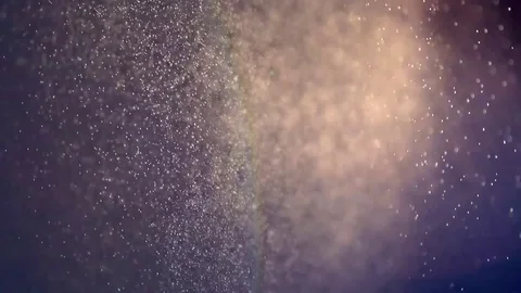 Rain water droplets raining in slow motion under sun light and dark background Stock Footage 76807054