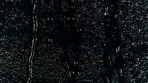 Rain water droplets trickling down the window pane at night Video stock 126137492