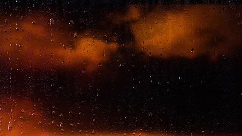 Rain water droplets trickling down the window pane at night Stock Footage 126137862