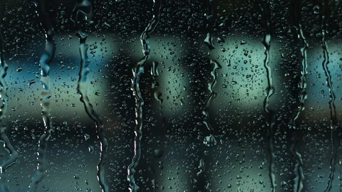 Rain water droplets trickling down the window pane at night Stock Footage 126140252