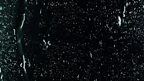 Rain water droplets trickling down the window pane at night Stock Footage 126141519