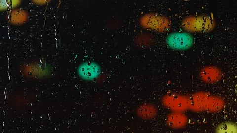 Rain water droplets trickling down the window pane at night Stock Footage 126143135