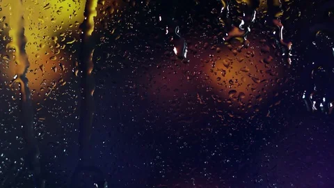 Rain water droplets trickling down the window pane at night Stock Footage 126145149