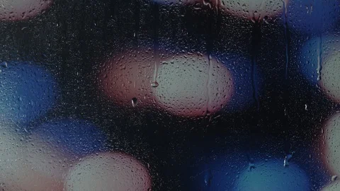 Rain water droplets trickling down the window pane at night Stock Footage 126147246