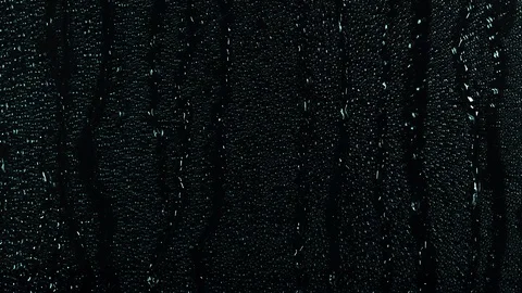 Rain water droplets trickling down the window pane at night Stock Footage 126151011