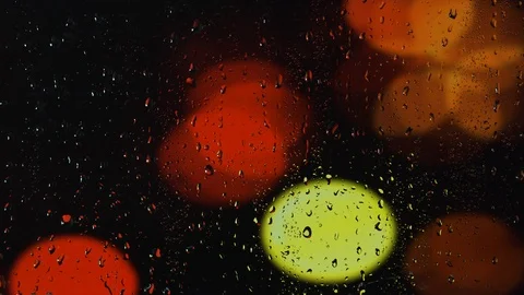 Rain water droplets trickling down the window pane at night Stock Footage 126153513
