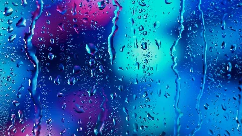 Rain water droplets trickling down the window pane ,blue background Video stock 126157648