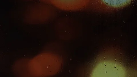 Rain water droplets trickling down the window pane at night Stock Footage 126158893
