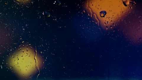 Rain water droplets trickling down the window pane at night Stock Footage 126203307