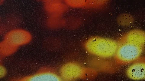 Rain water droplets trickling down the window pane at night Stock Footage 126203595