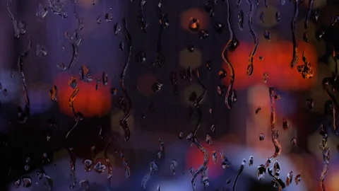 Rain water droplets trickling down the window on night background. Stock Footage 321532335
