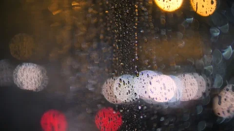 Rain Water Drops on Bus Window Glass in Rainy Day with Blurred Night City Stock Footage 82674690