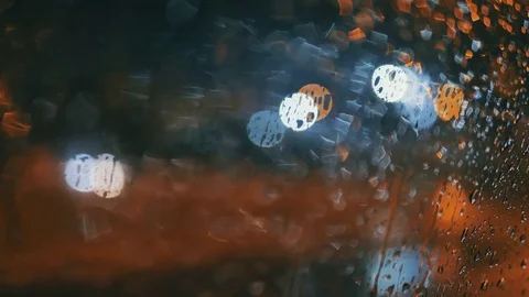 Rain Water Drops on car Window in Rainy night with Blurred Night City Traffic as Video stock 84763544