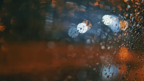 Rain Water Drops on car Window in Rainy night with Blurred Night City Traffic as Stock Footage 84763810