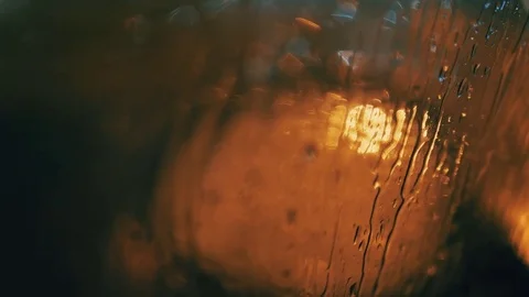 Rain Water Drops on car Window in Rainy night with Blurred Night City Traffic as Video stock 84764216