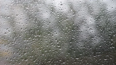 Rain water drops falling down on the window glass Stock Footage 142936503