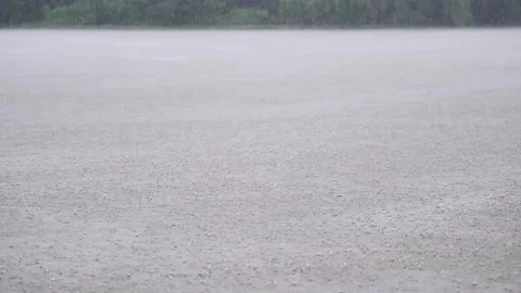 Rain water drops falling into lake in summer Stock Footage 136065985