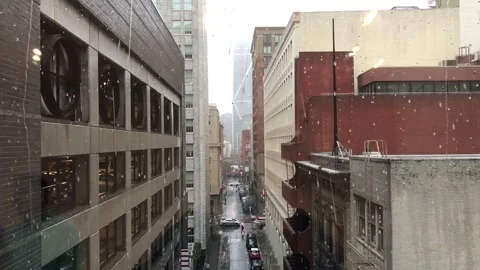 Rain water drops falling on a window glass facing the city Stock Footage 336249505