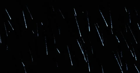 Rain, water drops fly falling on a black background, blending mode for motion Stock Footage 208143963