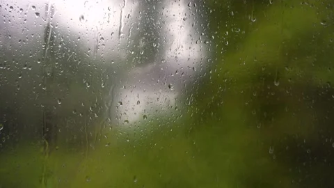 Rain water drops run on window glass. Autumn overcast windy rainy weather. Storm Stock Footage 141145077
