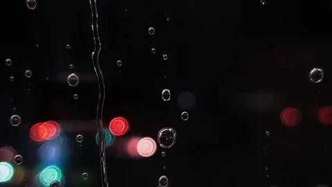 Rain Water Drops On Window Glass In Rainy season With traffic car Night Light Stock Footage