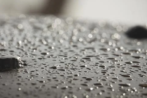 The rain water falling on the iron bar has created such a scene. Stock Photos
