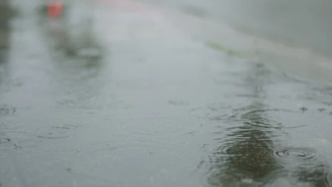 Rain water falling into a puddle Stock Footage 106628836