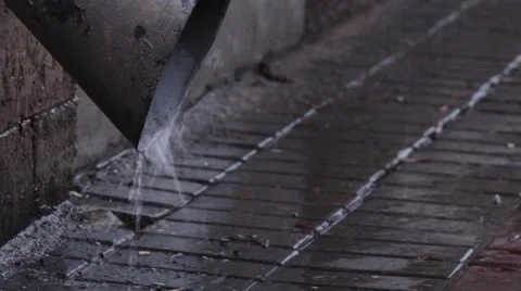 Rain water flowing from drain pipe closeup. passes by persons Stock Footage 63115664