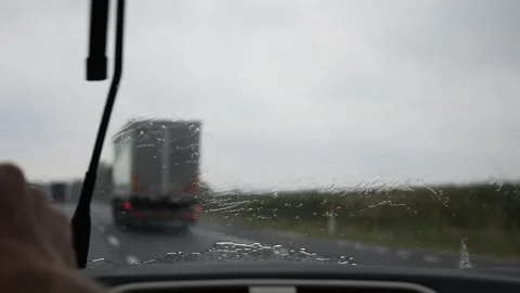 Rain water flows up on the car window during the high speed driving on highway Stock Footage 138773147