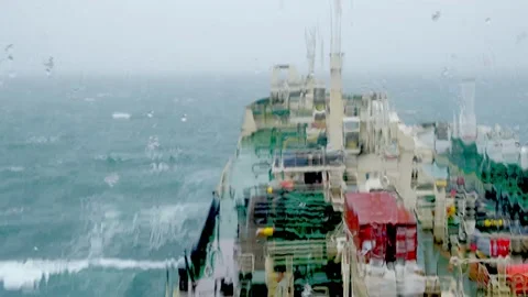 Rain water flows down blurred tankers during strong storm Stock Footage 135443458