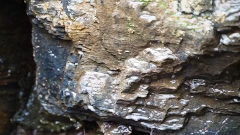 Rain water flows on the rocks on a rainy day Stock Footage 154750329