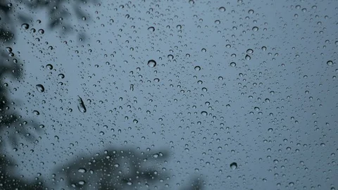 Rain water hitting glass on a cloudy day Stock Footage 94564111