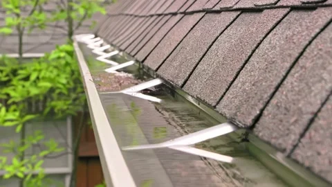 Rain water overflowing in gutter next to roof. Stock Footage 185860474