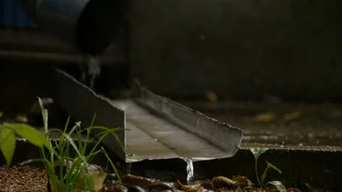 Rain water pouring from drainpipe Stock Footage 137960336