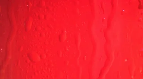 Rain water runs down red glass Stock Footage 11883170