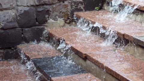 Rain water runs down the steps Foto stock