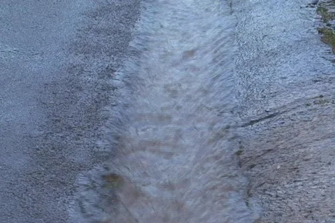 Rain water rushing in gutter 1 Stock Footage 821900