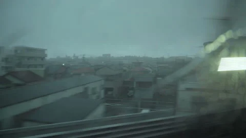 Rain water on a train window. View from a moving bullet train Shinkansen. Stock Footage 136514940
