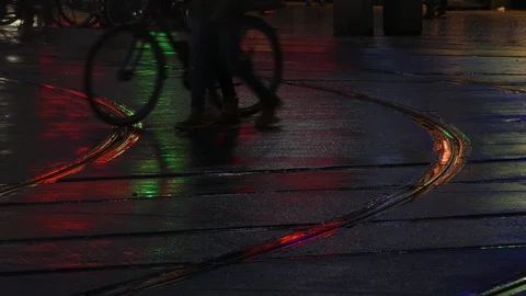 Rain wet road; lights; Tram rails and colorful water reflections in the rain Stock Footage 99532302