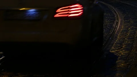Rain wet road; lights; Tram rails and water reflectios in the rain at dusk; B Stock Footage 99627483