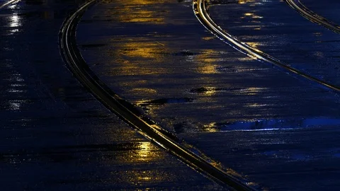 Rain wet road; lights; Tram rails and colorful water reflections in the rain Stock Footage 101026085